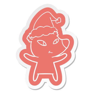 Noel Baba şapkası giyen bir ayının sevimli çizgi etiket