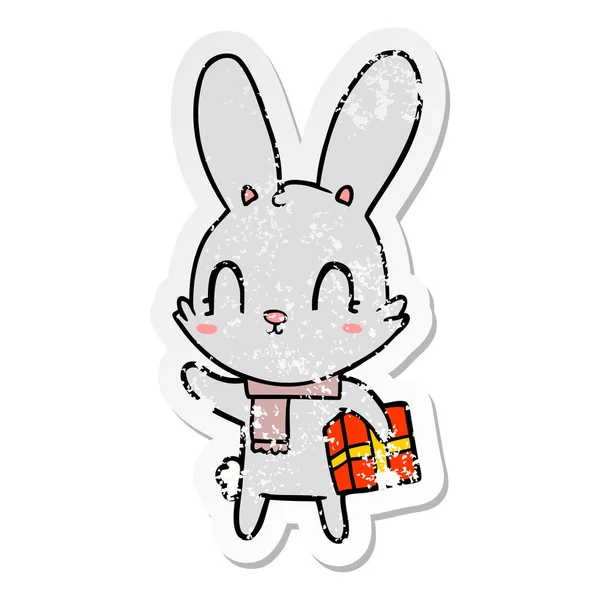 Distressed Sticker Cute Cartoon Rabbit Christmas Present — Stock Vector