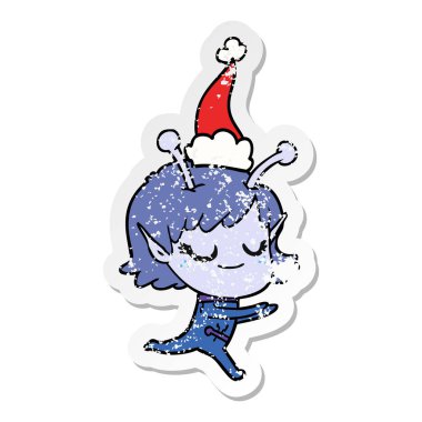 uzaylı kız elle çizilmiş gülümseyen etiket karikatür çalışan giyen Noel Baba şapkası, sıkıntılı