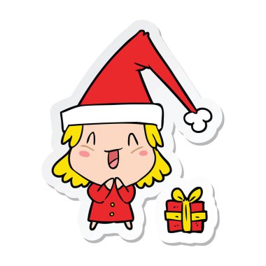 Noel şapka giyen bir çizgi film kız etiketi
