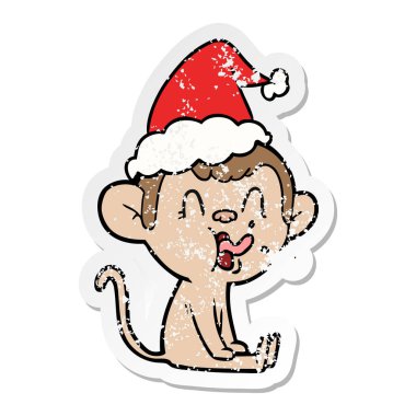 çılgın el bir maymun Santa şapka giyen oturan sıkıntılı Sticker karikatür çizilmiş