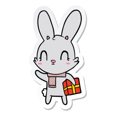 Noel hediyesi ile sevimli çizgi tavşan çıkartması