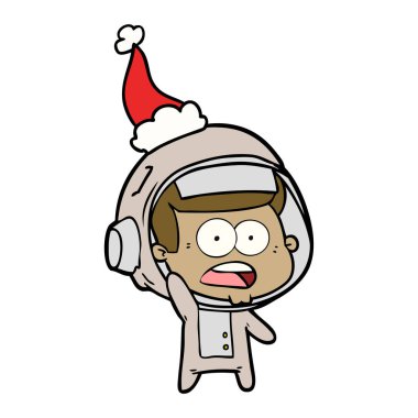 çizim için Noel Baba şapkası giyen sürpriz bir astronotun el çekilmiş