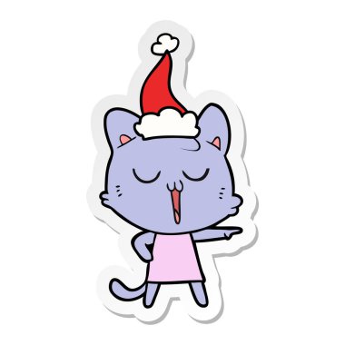 etiket karikatür Noel Baba şapkası giyen bir kedi şarkı el çekilmiş