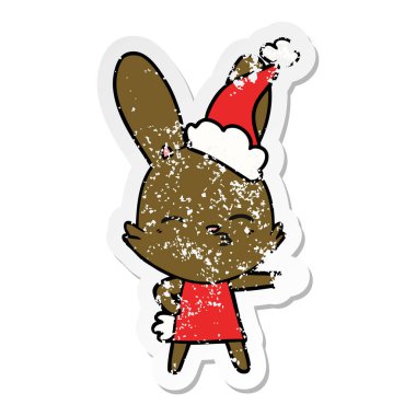 meraklı bunny el sıkıntılı etiket karikatür giyen Noel Baba şapkası, çekilmiş