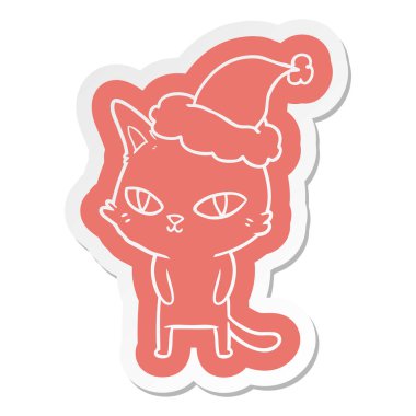 Noel Baba şapkası giyen Parlak gözlü bir kedinin ilginç çizgi film etiketi