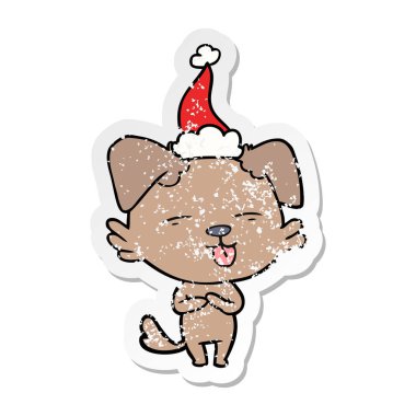 sıkıntılı etiket karikatür bir köpek Noel Baba şapkası giyen dilini el çekilmiş