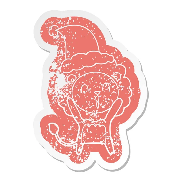 Skrattande lejon tecknad nödställda klistermärke av en bär santa hatt — Stock vektor