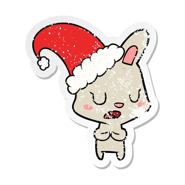 Etiqueta angustiada de um coelho dos desenhos animados usando chapéu de Natal —  Vetores de Stock