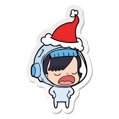 etiket karikatür giyen Noel Baba şapkası açıklayan bir astronot kadının el çekilmiş