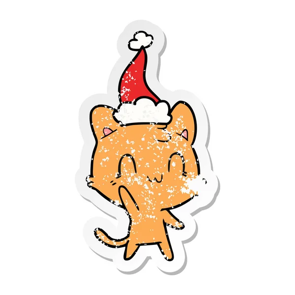 Autocollant en détresse dessin animé d'un chat heureux portant un chapeau de Père Noël — Image vectorielle