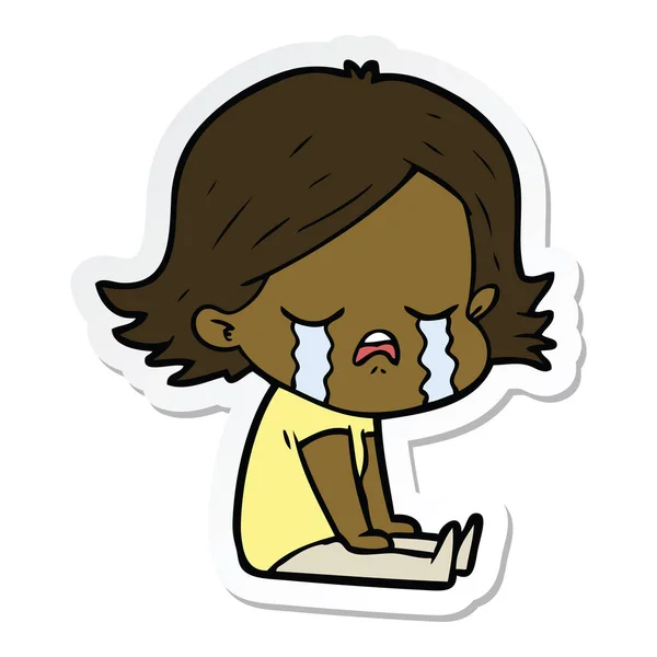 Sticker of a cartoon girl crying sat on floor — Stock Vector