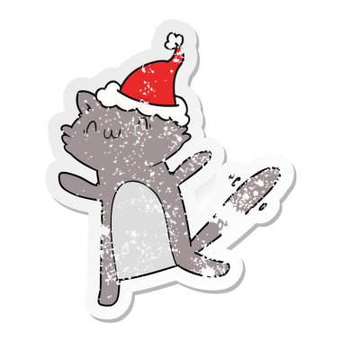 sıkıntılı etiket karikatür Noel Baba şapkası giyen bir dans eden kedi el çekilmiş