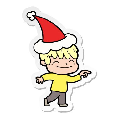 etiket karikatür Noel Baba şapkası giyen bir mutlu çocuk