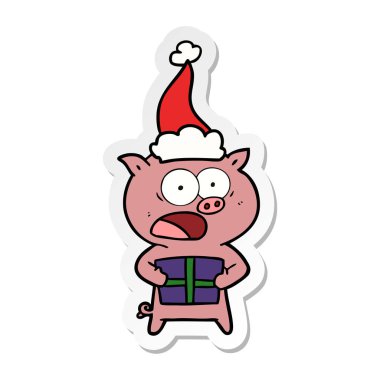 etiket karikatür Noel Noel Baba şapkası giyen hediyesi ile domuz bir el çekilmiş
