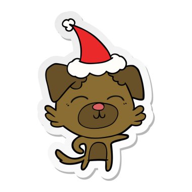 etiket karikatür giyen Noel Baba şapkası işaret eden bir köpek