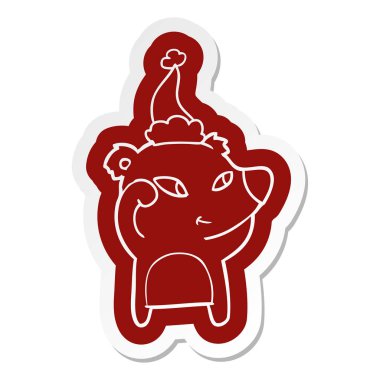 Noel Baba şapkası giyen bir ayının sevimli ilginç çizgi etiket