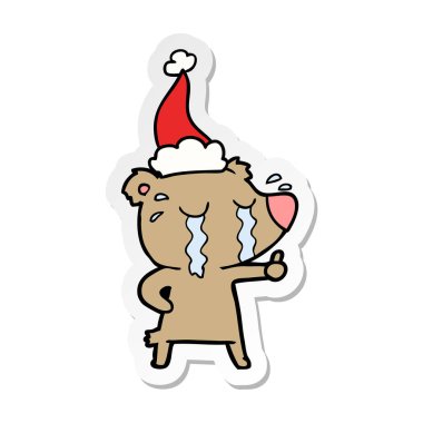 etiket karikatür Noel Baba şapkası giyen bir ağlayan ayının el çekilmiş