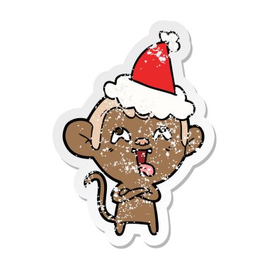 sıkıntılı etiket karikatür Noel Baba şapkası giyen bir maymunun deli el çekilmiş