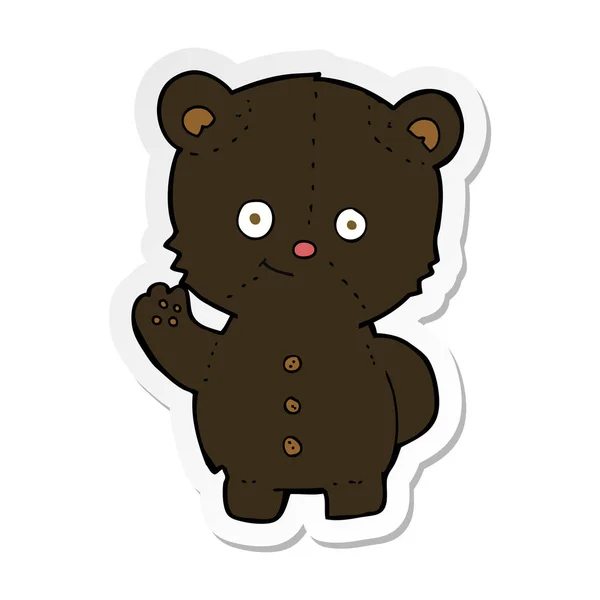 Sticker of a cartoon waving black bear cub — Stock Vector