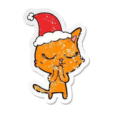 Sakin elle çizilmiş etiket karikatür Noel Baba şapkası giyen bir kedi sıkıntılı