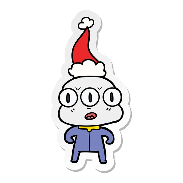 Hand Drawn Sticker Cartoon Three Eyed Alien Wearing Santa Hat — Stock Vector