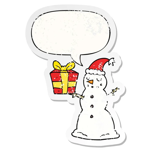 Bonhomme de neige dessin animé et présent et bulle de la parole autocollant affligé — Image vectorielle