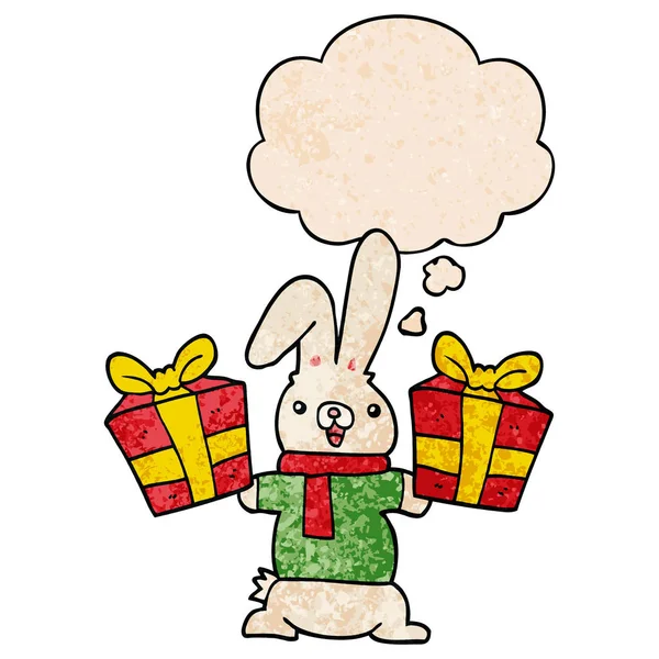 Cartoon rabbit with christmas presents and thought bubble in gru — Stock Vector
