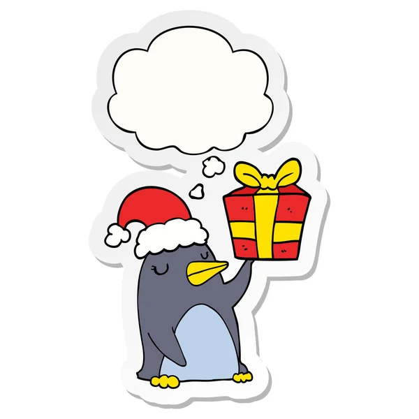 Cartoon penguin with christmas present and thought bubble as a p — Stock Vector