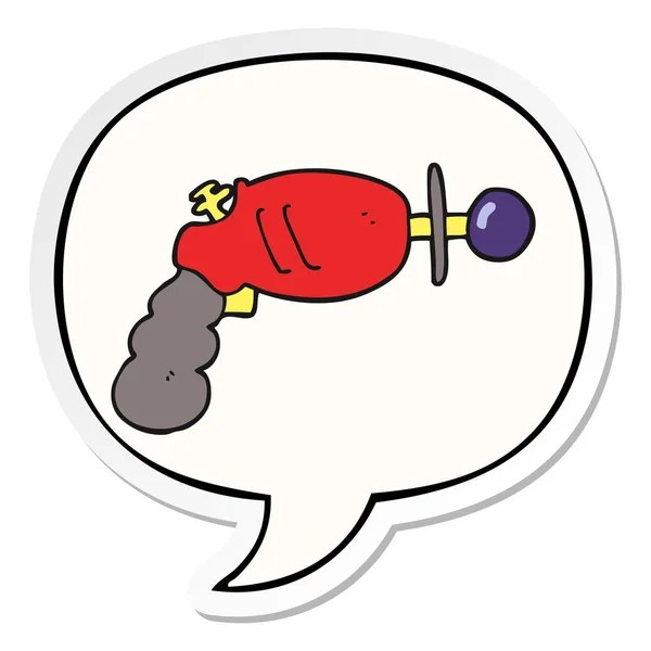 Cartoon ray gun and speech bubble sticker — Stock Vector