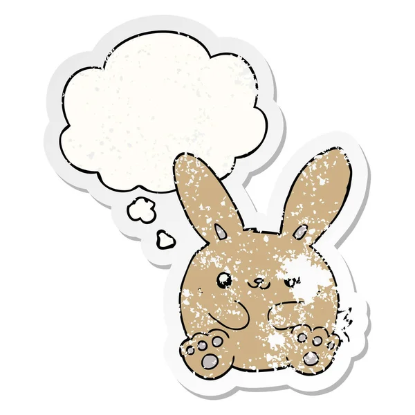 Cartoon rabbit and thought bubble as a distressed worn sticker — Stock Vector