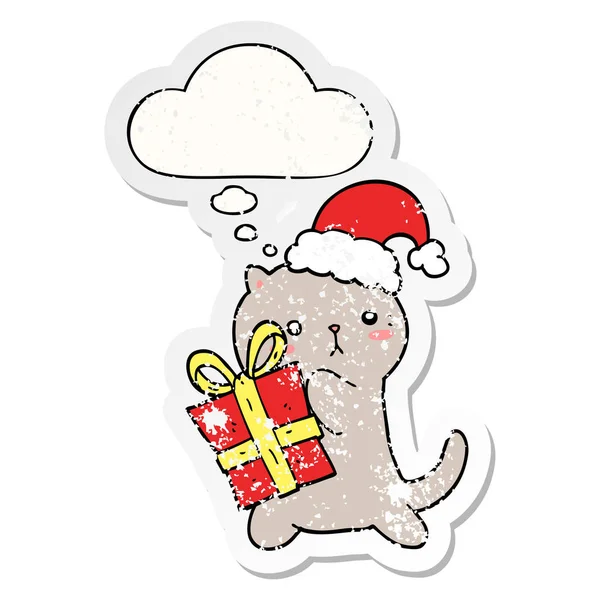 Cute cartoon cat carrying christmas present and thought bubble a — Stock Vector