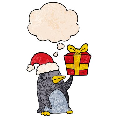 noel hediyesi ve gru düşünce balonu ile karikatür penguen
