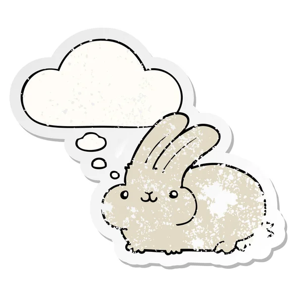 Cartoon rabbit and thought bubble as a distressed worn sticker — Stock Vector