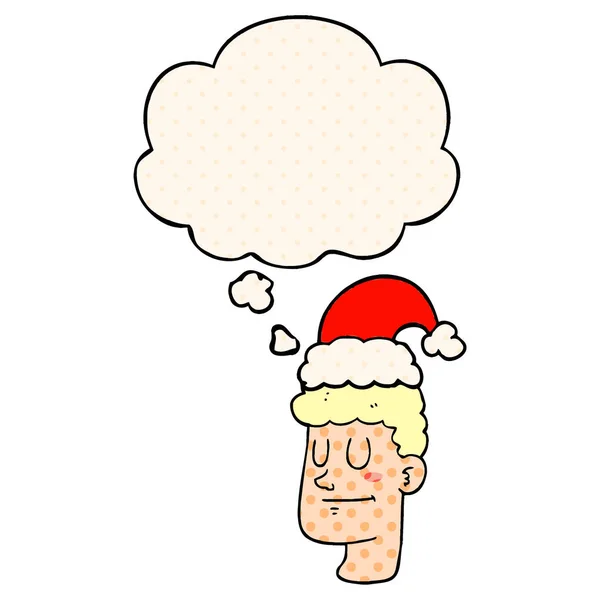 Cartoon man wearing christmas hat and thought bubble in comic bo — Stock Vector