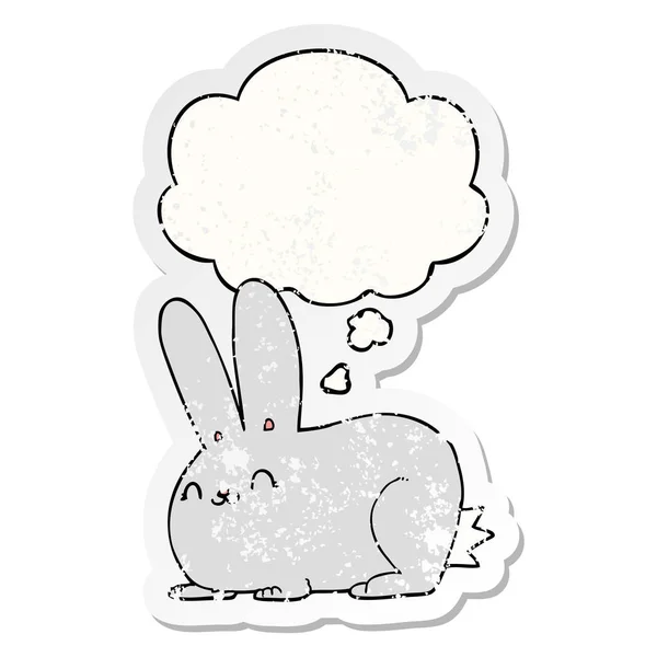 Lapin dessin animé et bulle de pensée comme un autocollant usé affligé — Image vectorielle