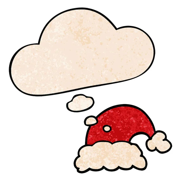 Cartone animato cappello di Natale e bolla di pensiero in grunge patte texture — Vettoriale Stock