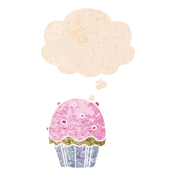 Cartoon cupcake en dacht bubble in retro getextureerde stijl — Stockvector