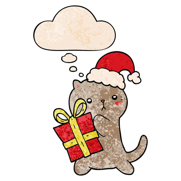 Cute cartoon cat carrying christmas present and thought bubble i — Stock Vector