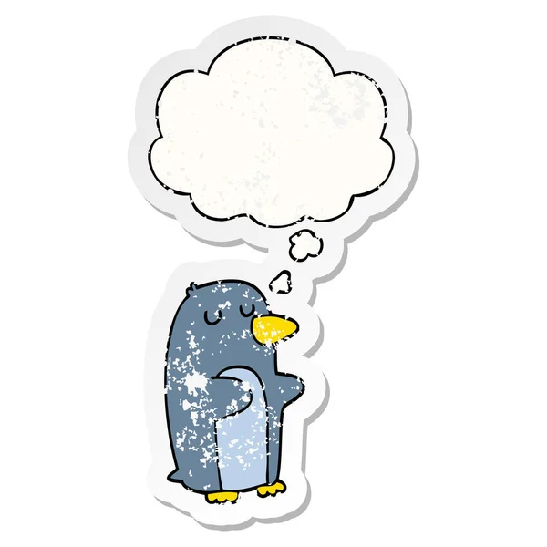 Cartoon penguin and thought bubble as a distressed worn sticker — Stock Vector