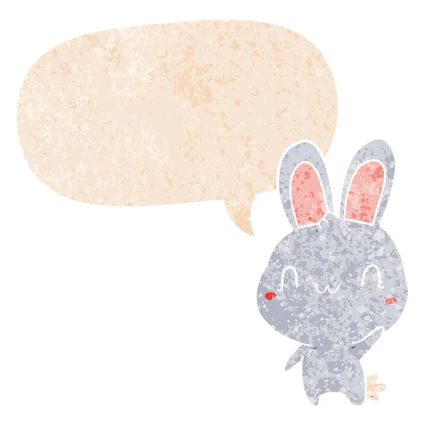 Cartoon rabbit waving and speech bubble in retro textured style — Stock Vector