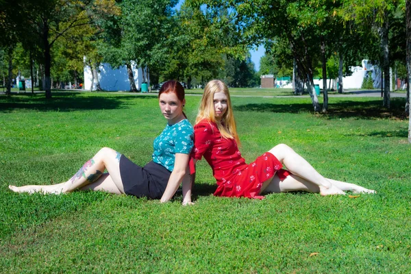 Dos Chicas Están Sentadas Hierba Verde Fondo Los Árboles — Foto de Stock