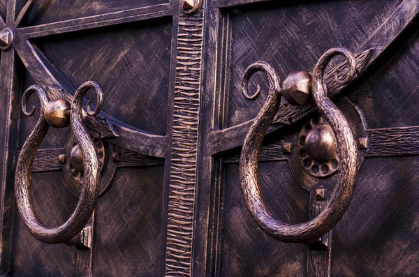 Door handles of metal gates. Decorative forging