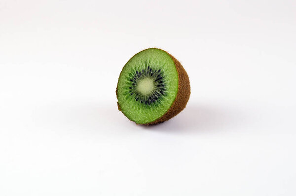 Half of the green kiwi on a light background