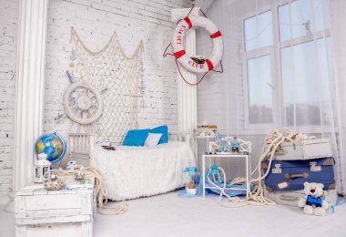 Beautiful location in a photo Studio in a sea style in white colors for a photosession on a brick wall background clipart