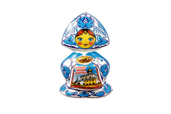 ceramic souvenir toy in the form of matryoshka with beautiful color painting on isolated white background reflecting the national Russian culture