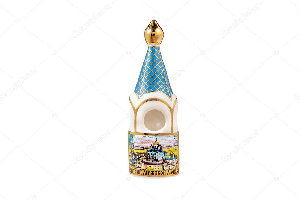 ceramic souvenir toy in the form of temple with beautiful color painting on isolated white background reflecting the national Russian culture with the inscription in Russian: friary