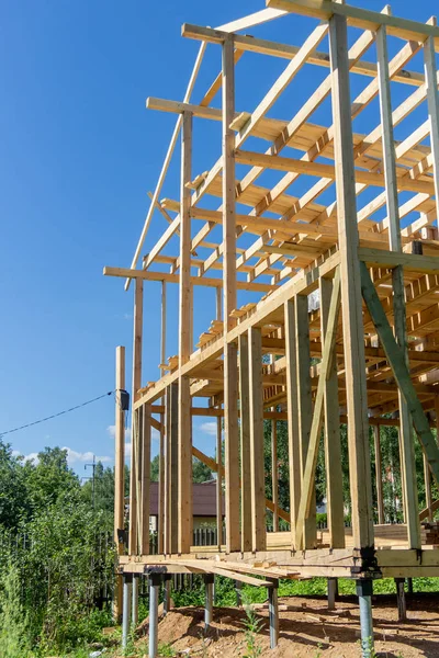 wooden interior frame of a new house under building, architectural residential construction stick built home framework.