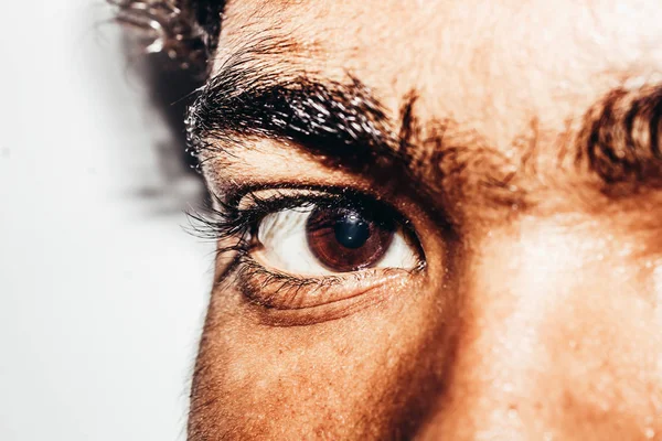 Macro shot of young man\'s eye: The human eye sideways, Close-up, isolated on white background