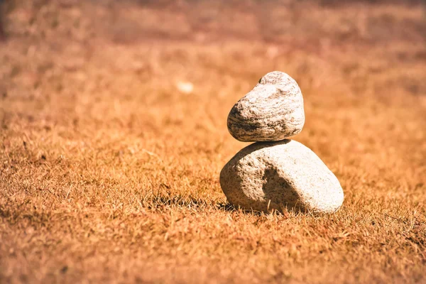 Heap of white stone stack of rock decoration in vertical style composition, copy space. Harmony, stability, strength, well being, concept. Useful in health, spa-therapy, alternative, medicine industry